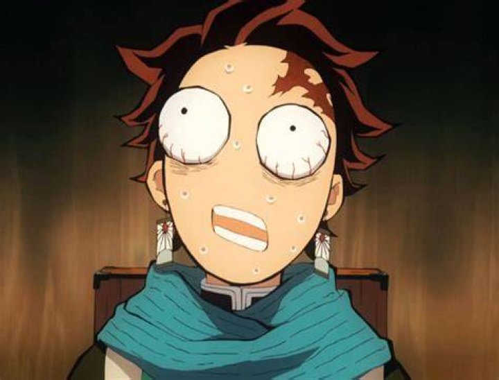 Tanjiro looking stressed in the middle of a fight in Demon Slayer.